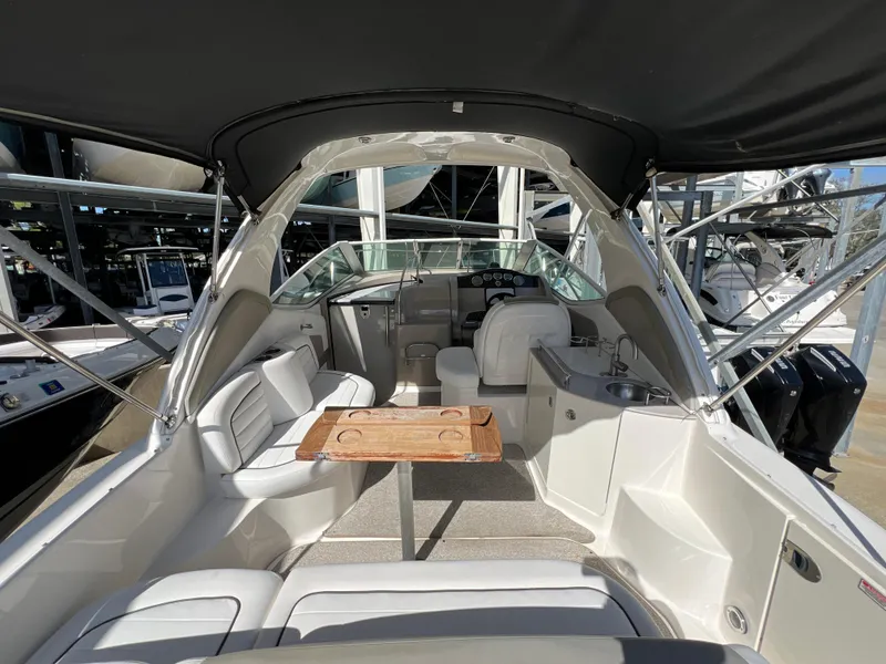 Slide: The Image of 2006 Sea Ray 290 Sundancer interior with seating, table, and helm. - 17