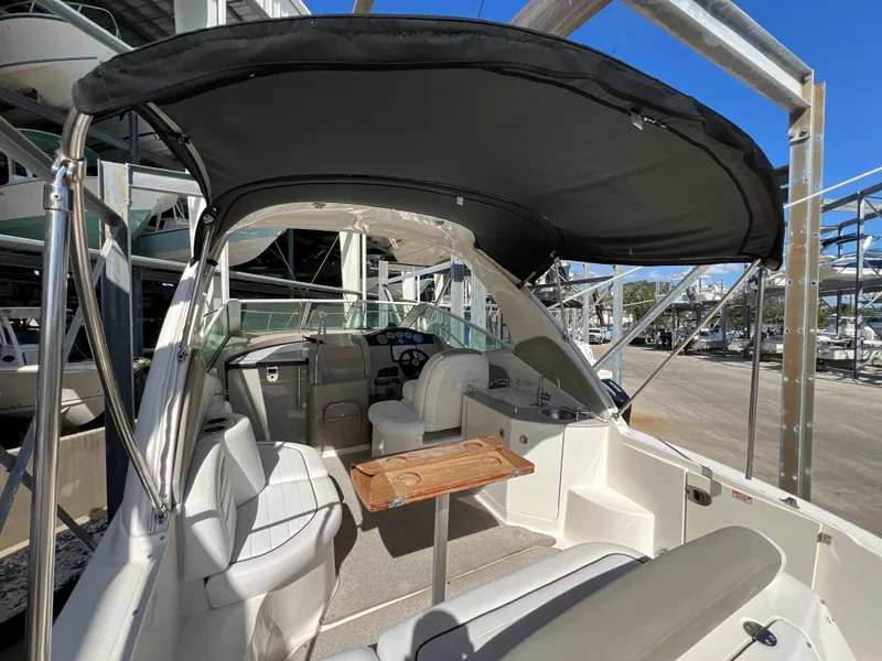 Slide: The Image of 2006 Sea Ray 290 Sundancer boat interior with seating and canopy. - 18