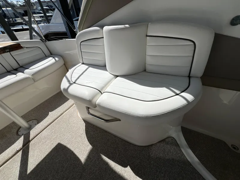 Slide: The Image of 2006 Sea Ray 290 Sundancer interior seating with white upholstery and modern design. - 20