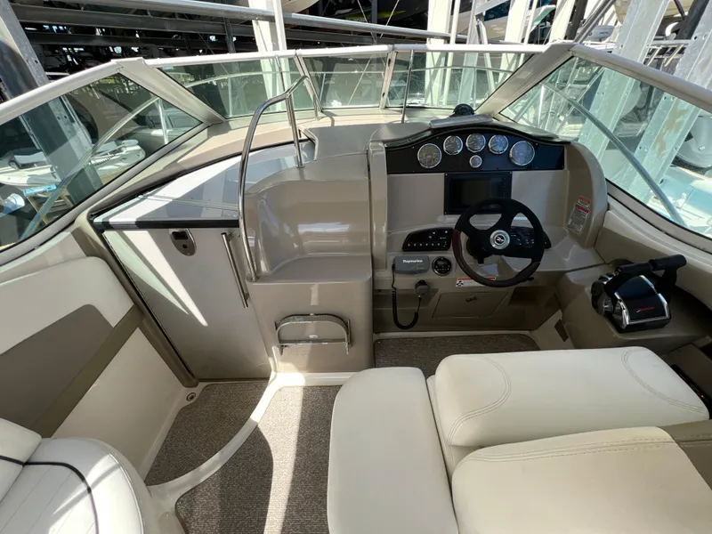 Slide: The Image of 2006 Sea Ray 290 Sundancer helm with modern controls and comfortable seating. - 21