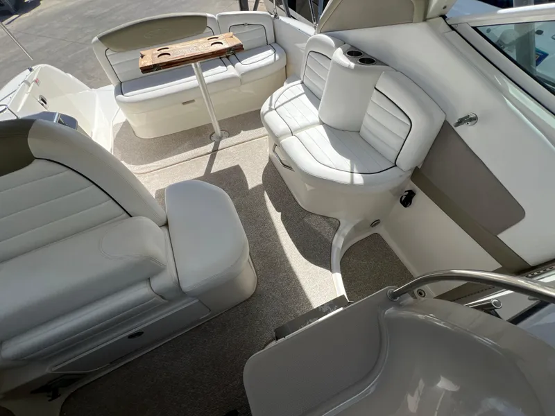 Slide: The Image of Interior of 2006 Sea Ray 290 Sundancer boat with white seating and table. - 25