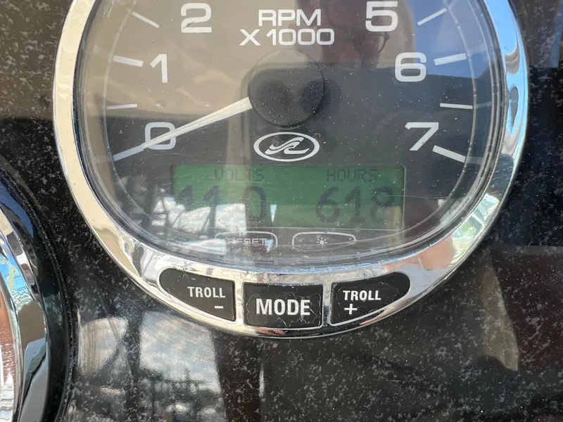 Slide: The Image of Close-up of 2006 Sea Ray 290 Sundancer RPM gauge displaying 1100 RPM and 619 hours. - 28