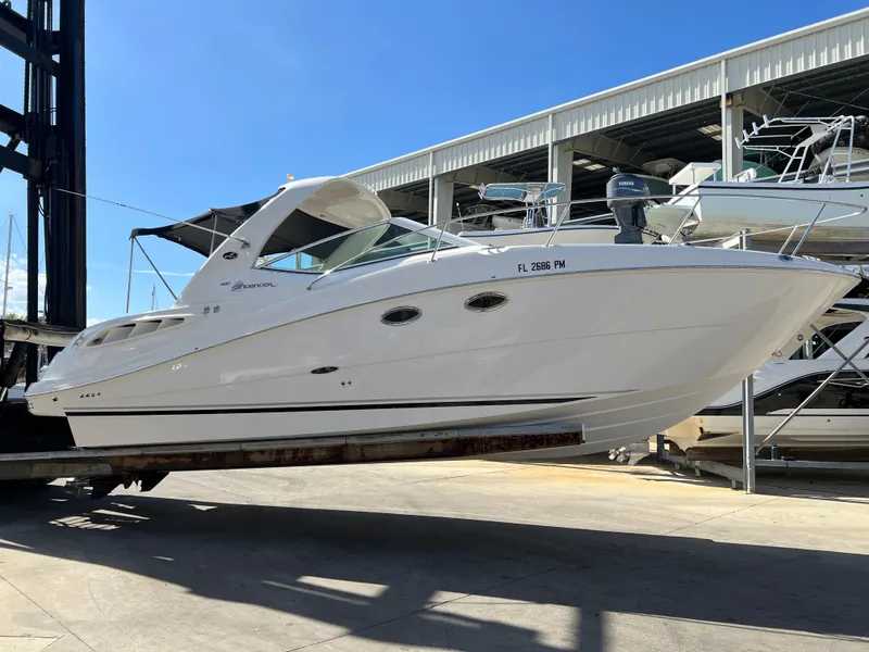 Slide: The Image of 2006 Sea Ray 290 Sundancer boat on a lift in a marina. - 4