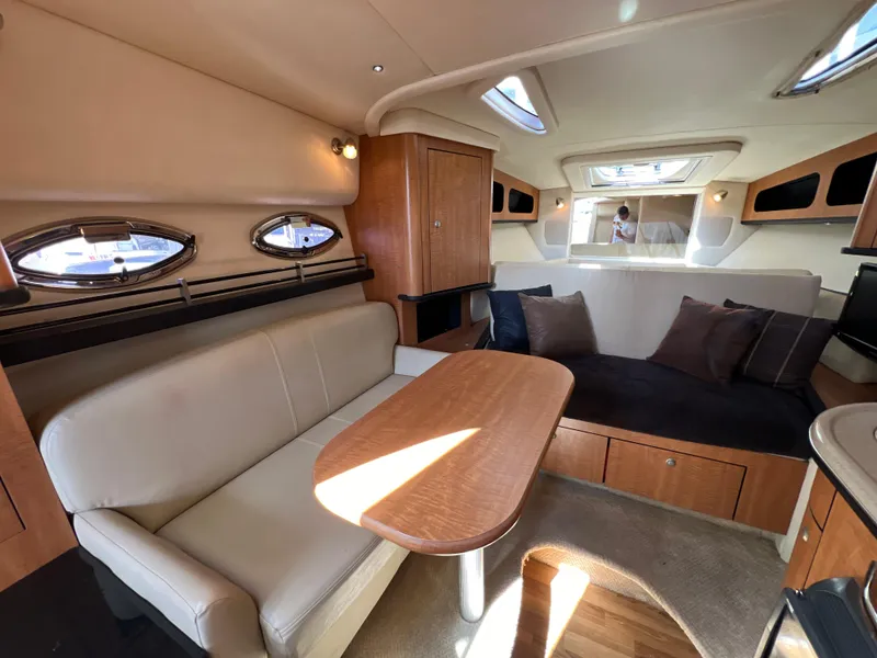 Slide: The Image of Luxurious 2006 Sea Ray 290 Sundancer cabin interior with seating and table. - 7