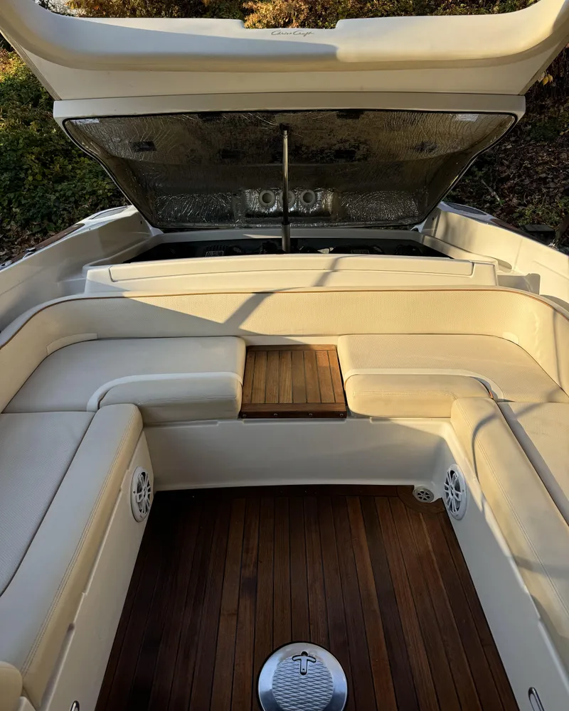 Slide: The Image of 2008 Chris-Craft Launch 28 boat interior with open engine hatch and teak flooring. - 10