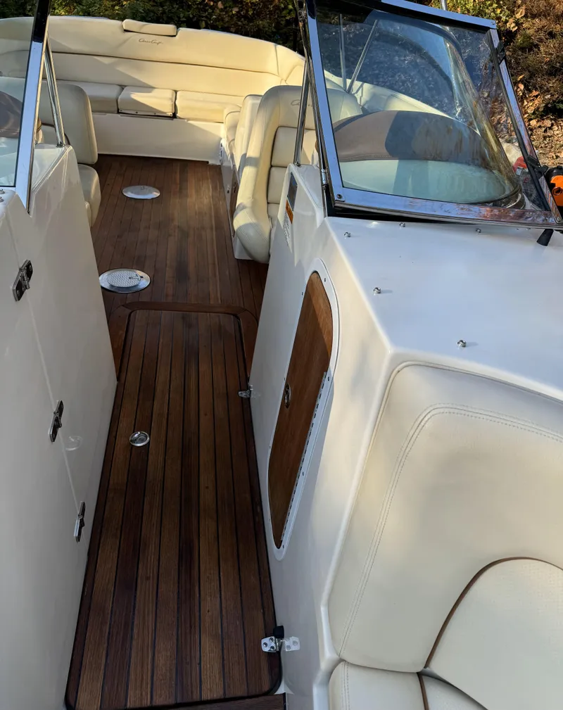 Slide: The Image of 2008 Chris-Craft Launch 28 boat interior with wooden deck and white seating. - 11
