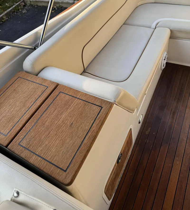 Slide: The Image of 2008 Chris-Craft Launch 28 interior with wooden accents and beige seating. - 12