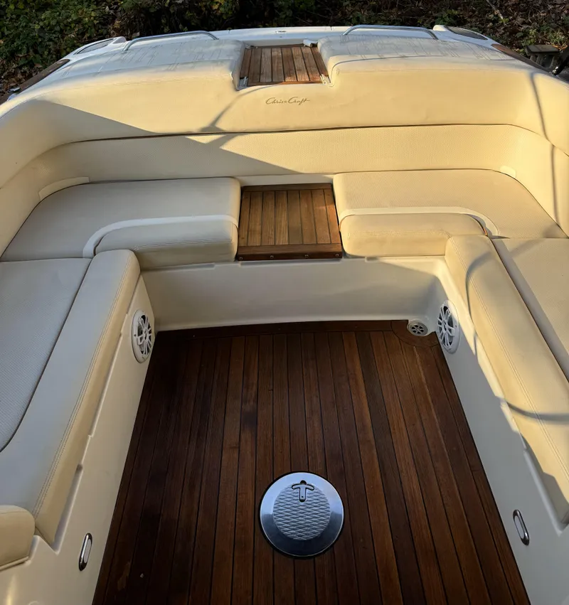 Slide: The Image of 2008 Chris-Craft Launch 28 boat interior with teak flooring and cushioned seating. - 7