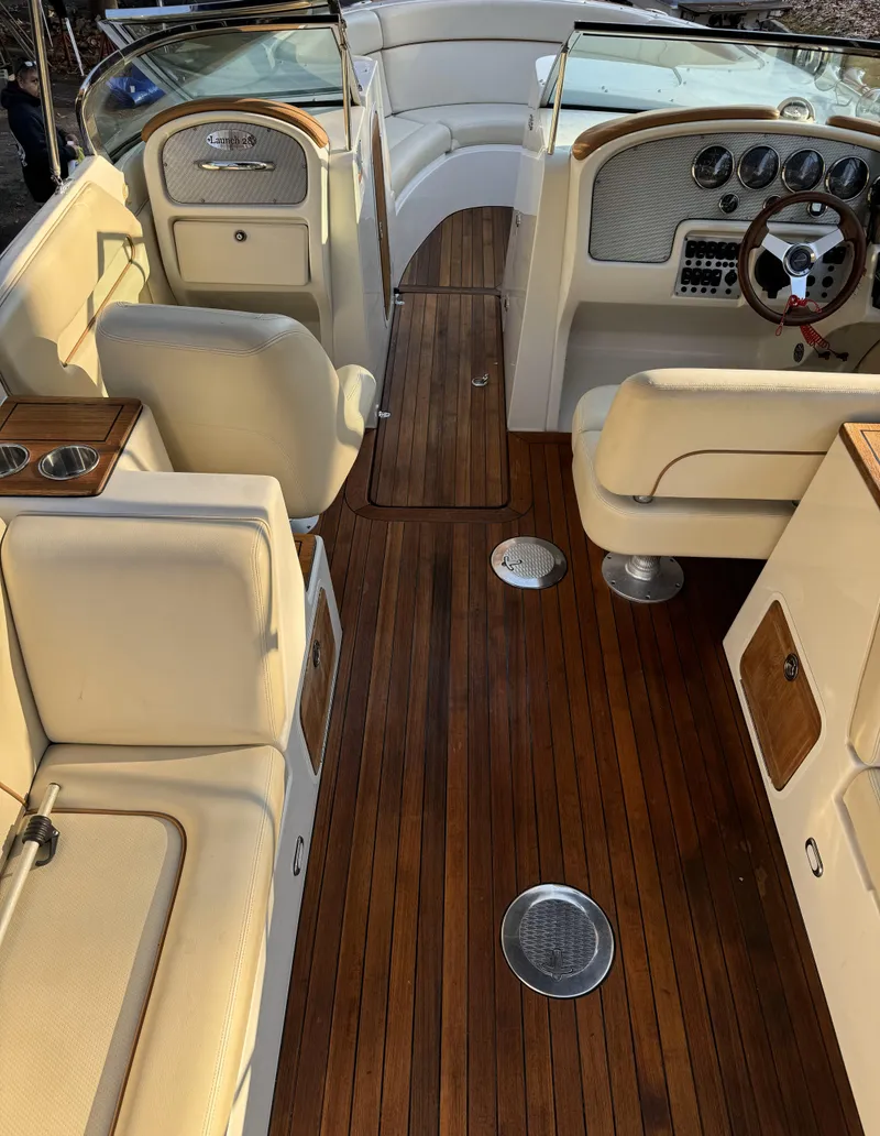 Slide: The Image of 2008 Chris-Craft Launch 28 interior with elegant wood flooring and cream seating. - 8