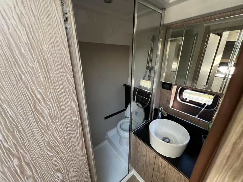 Slide: The Image of Luxurious bathroom in 2017 Azimut 43 ATLANTIS yacht with modern fixtures and wood accents. - 42