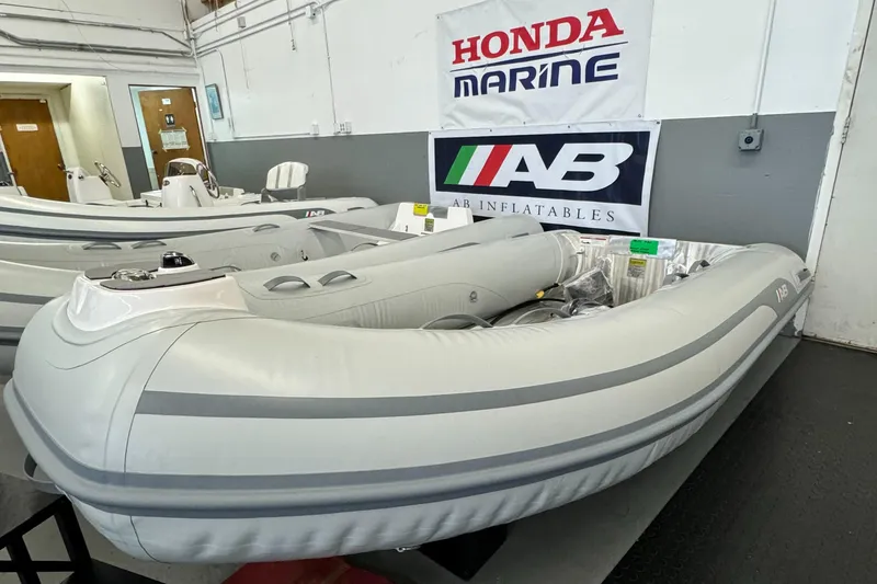 Slide: The Image of 2024 AB Inflatables Alumina 10 ALX boat interior with steering wheel and seating. - 2