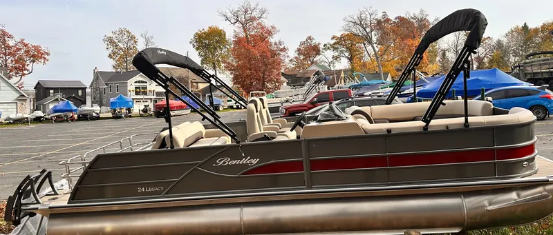 Slide: The Image of 2025 Bentley Pontoons Legacy 243 Swingback in a parking lot with autumn trees. - 10
