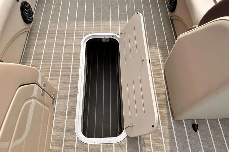 Slide: The Image of 2025 Bentley Pontoons Legacy 243 Swingback interior storage compartment open on deck. - 14