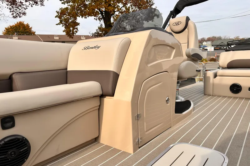 Slide: The Image of 2025 Bentley Pontoons Legacy 243 Swingback interior with beige seating and helm. - 15
