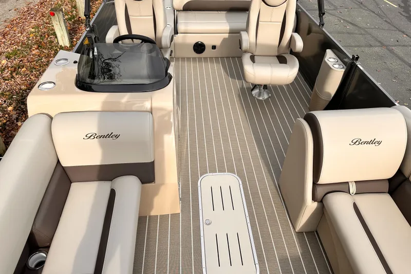 Slide: The Image of 2025 Bentley Pontoons Legacy 243 Swingback interior with beige seating and sleek design. - 16