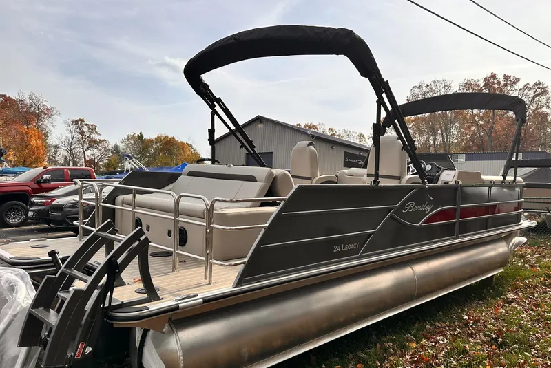 Slide: The Image of 2025 Bentley Pontoons Legacy 243 Swingback, sleek design, outdoor setting, autumn background. - 2