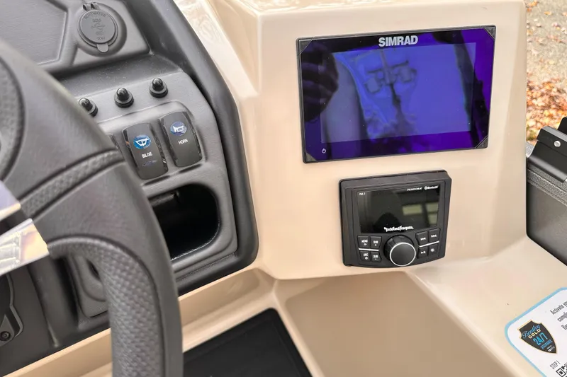Slide: The Image of 2025 Bentley Pontoons Legacy 243 Swingback dashboard with Simrad display and controls. - 21