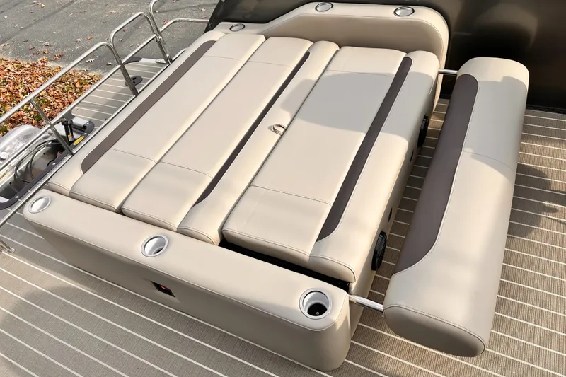 Slide: The Image of 2025 Bentley Pontoons Legacy 243 Swingback seating area with beige upholstery and cup holders. - 26