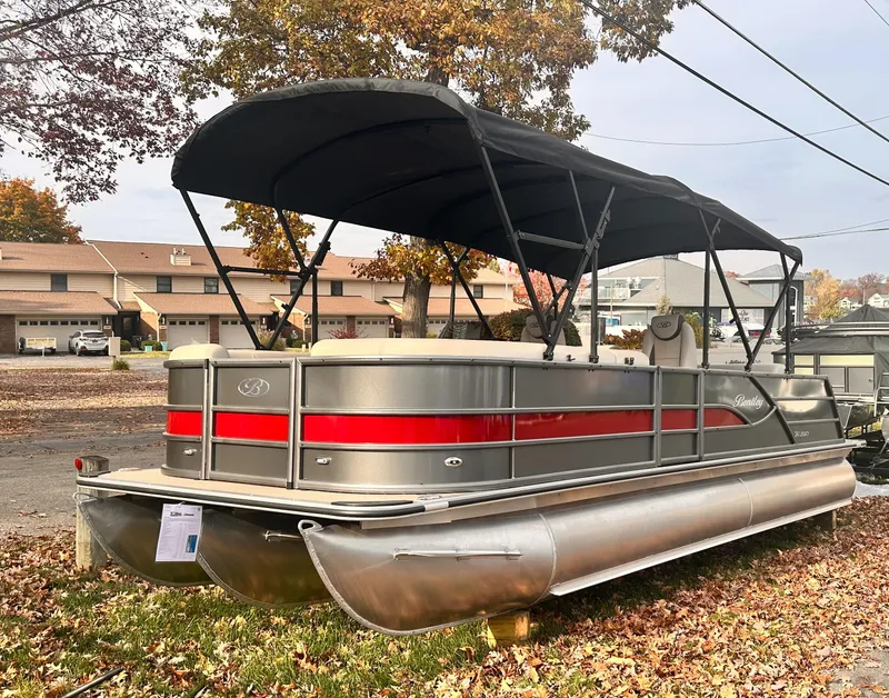Slide: The Image of 2025 Bentley Pontoons Legacy 243 Swingback with canopy, parked on autumn leaves. - 7