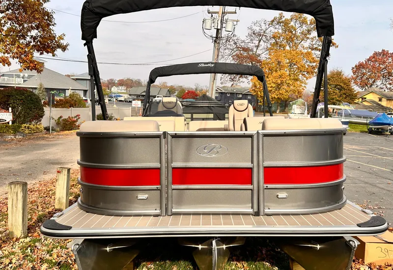 Slide: The Image of 2025 Bentley Pontoons Legacy 243 Swingback, sleek design, parked outdoors in autumn setting. - 8