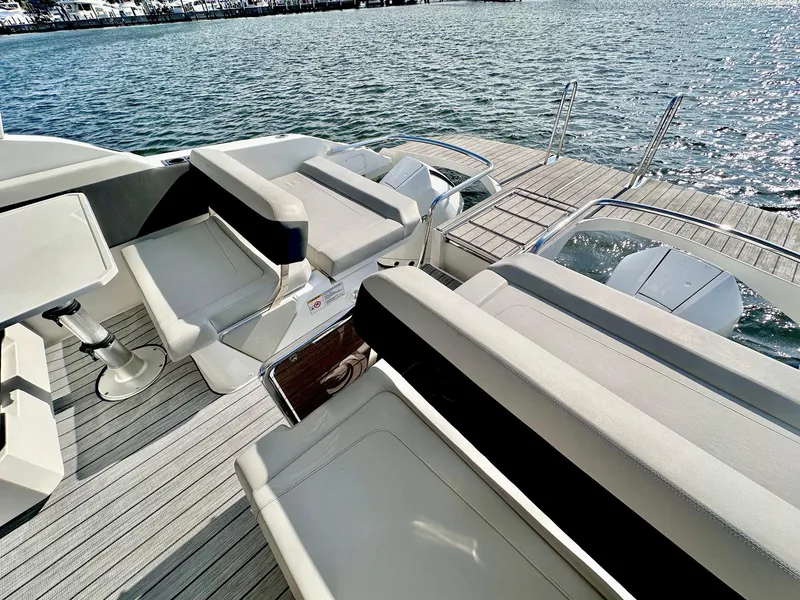 Slide: The Image of Aquila 32 Sport 2020 boat interior with seating and water view. - 11
