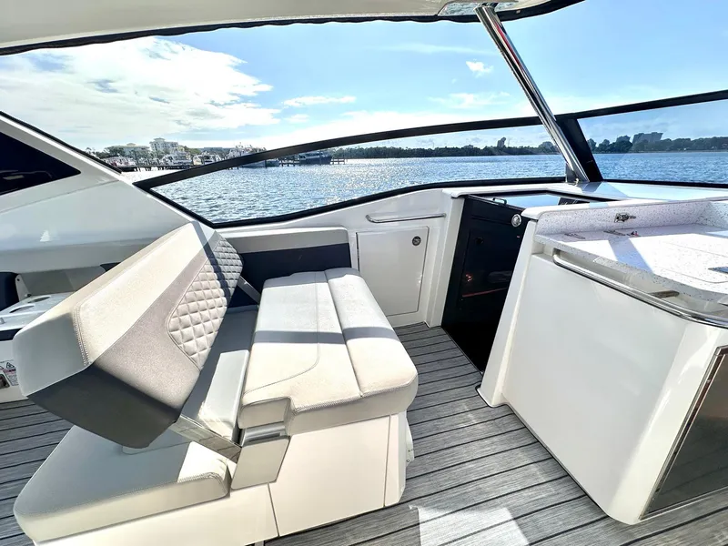 Slide: The Image of 2020 Aquila 32 Sport yacht interior with seating and scenic water view. - 12