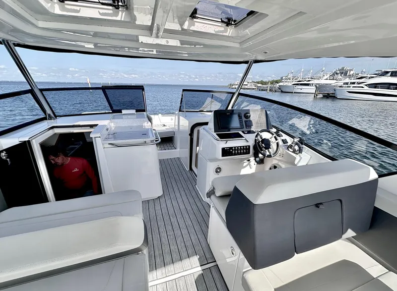 Slide: The Image of Aquila 32 Sport 2020 yacht interior with helm, seating, and ocean view. - 15