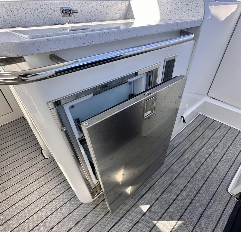 Slide: The Image of Aquila 32 Sport 2020 boat interior with open stainless steel storage compartment. - 17