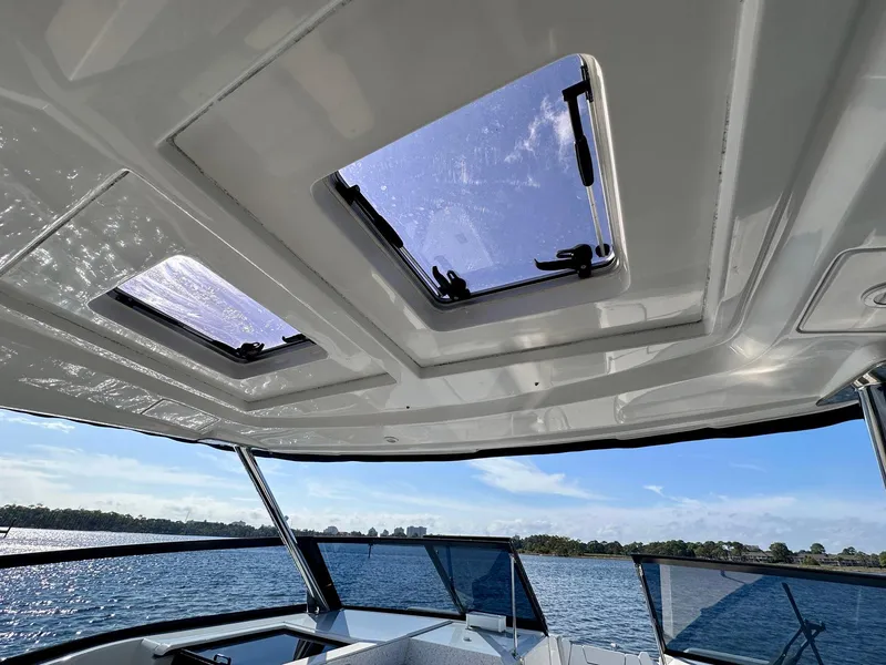 Slide: The Image of Aquila 32 Sport 2020 boat interior with skylights and scenic water view. - 21