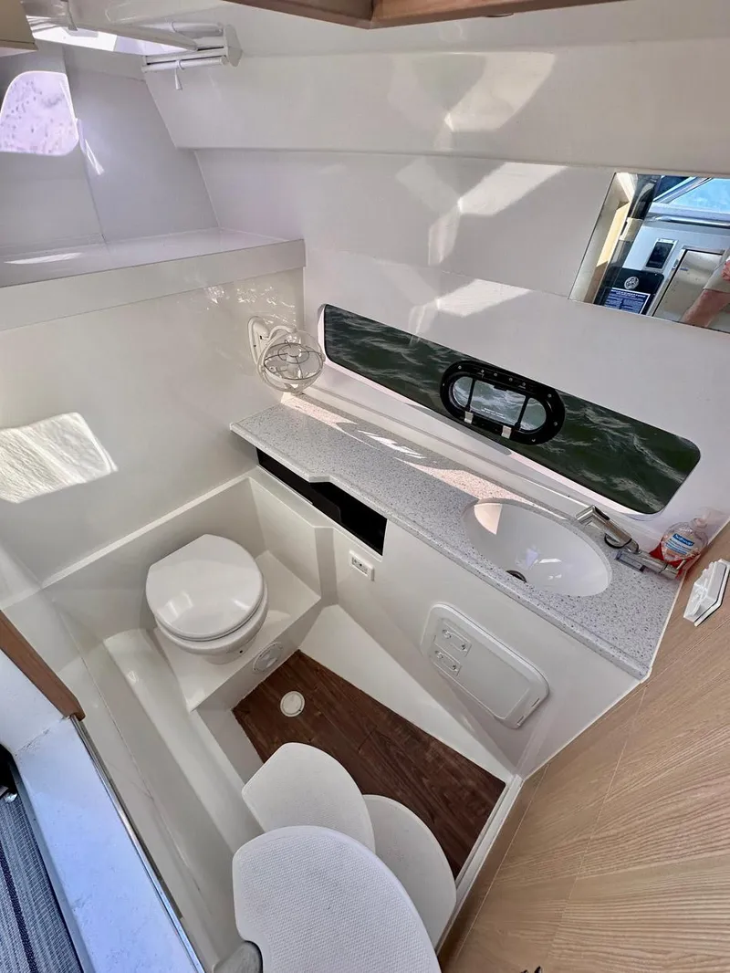 Slide: The Image of 2020 Aquila 32 Sport boat bathroom with modern fixtures and natural light. - 25
