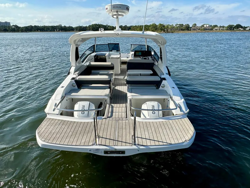 Slide: The Image of Aquila 32 Sport 2020 boat on water, rear view with spacious deck and seating. - 5