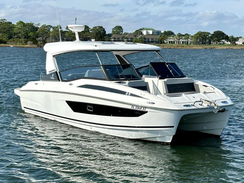 Slide: The Image of 2020 Aquila 32 Sport boat on water, sleek design, sunny day. - 8