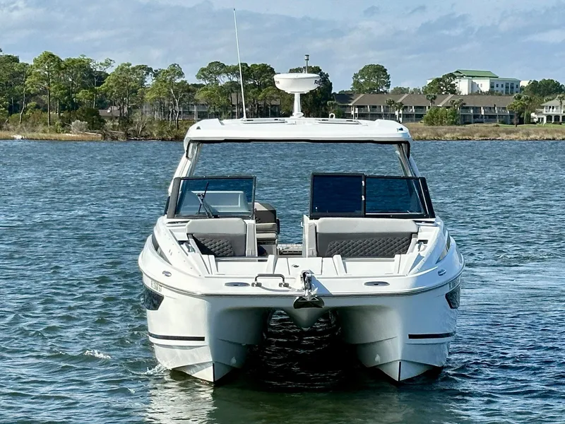Slide: The Image of Aquila 32 Sport 2020 catamaran on water, front view, with scenic background. - 9