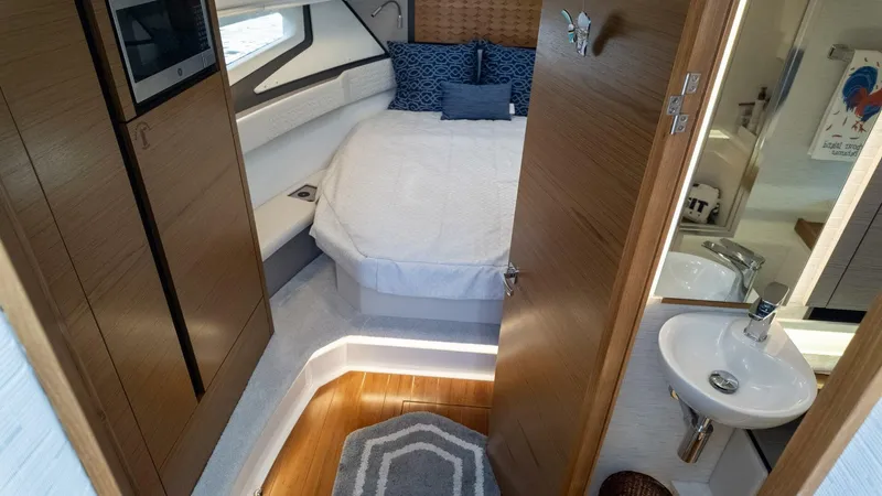 Slide: The Image of Luxurious 2022 Tiara Yachts 43 LE cabin interior with bed, sink, and modern amenities. - 11