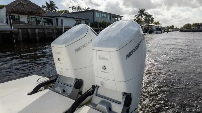 Slide: The Image of 2022 Tiara Yachts 43 LE with dual Mercury outboard engines on a sunny waterfront. - 5