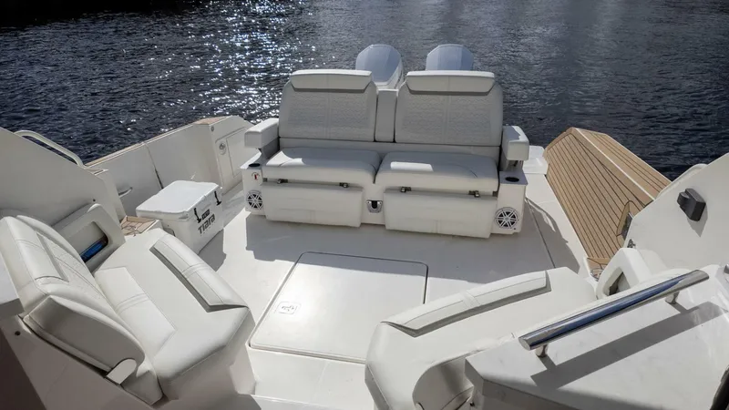 Slide: The Image of 2022 Tiara Yachts 43 LE boat interior with white seating and water view. - 7