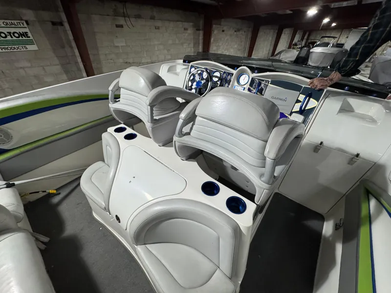 Slide: The Image of 2006 MTI 44 Pleasure Cat boat interior with white seating and dashboard. - 18