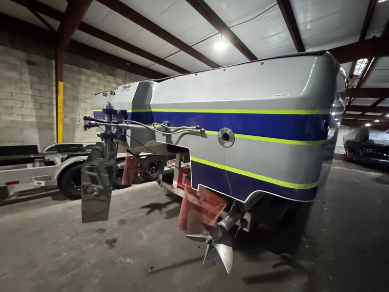 Slide: The Image of 2006 MTI 44 Pleasure Cat boat in warehouse, rear view with propellers visible. - 6