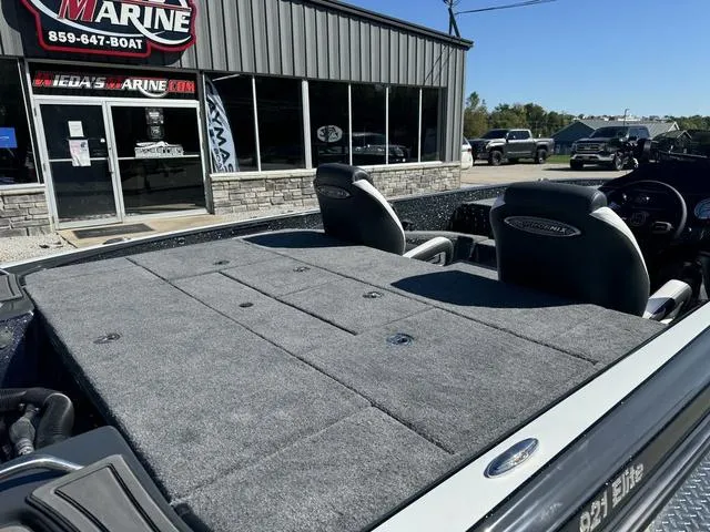 Slide: The Image of 2025 Phoenix 921 ELITE boat at dealership, featuring spacious deck and seating. - 11