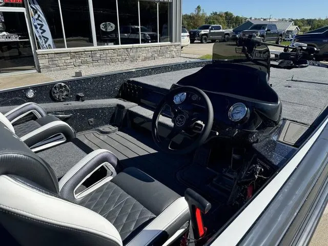 Slide: The Image of 2025 Phoenix 921 ELITE boat interior with steering wheel and seating. - 12