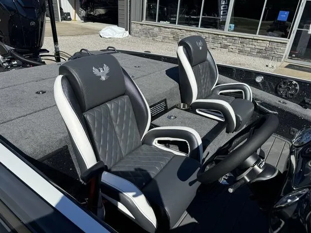 Slide: The Image of 2025 Phoenix 921 ELITE boat interior with black and white leather seats. - 13