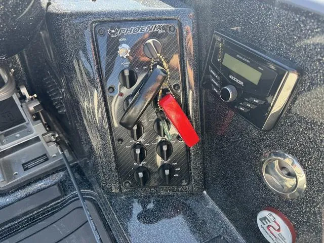 Slide: The Image of Phoenix 921 ELITE 2025 boat dashboard with control panel and audio system. - 15