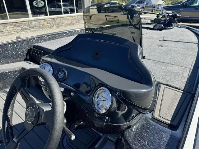 Slide: The Image of 2025 Phoenix 921 ELITE boat dashboard with steering wheel and gauges. - 16