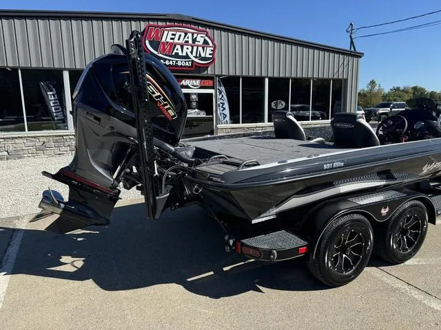 Slide: The Image of 2025 Phoenix 921 ELITE boat at Wieda's Marine dealership, featuring sleek design and powerful engine. - 2