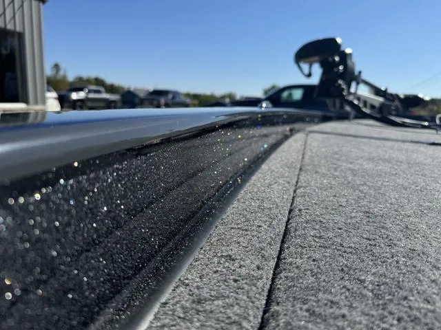 Slide: The Image of Close-up of 2025 Phoenix 921 ELITE boat deck with sparkling finish under clear sky. - 25