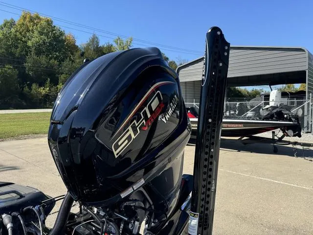 Slide: The Image of Phoenix 921 ELITE 2025 boat with powerful SHO engine, parked outdoors. - 28