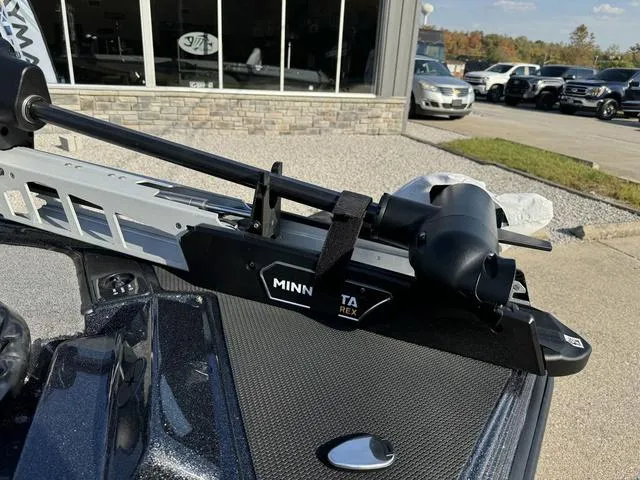Slide: The Image of Phoenix 921 ELITE 2025 with Minn Kota trolling motor in dealership lot. - 11