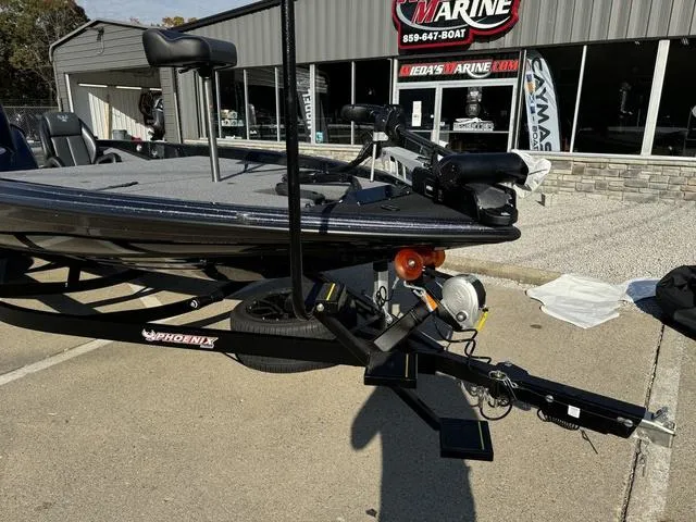 Slide: The Image of 2025 Phoenix 921 ELITE boat on trailer outside marine shop. - 12