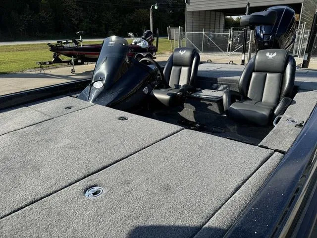 Slide: The Image of 2025 Phoenix 921 ELITE boat interior with dual black seats and spacious deck. - 15