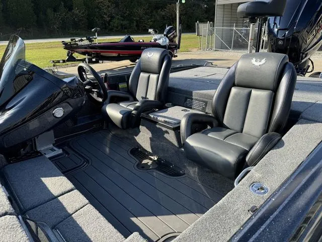 Slide: The Image of 2025 Phoenix 921 ELITE boat interior with black leather seats and modern dashboard. - 16